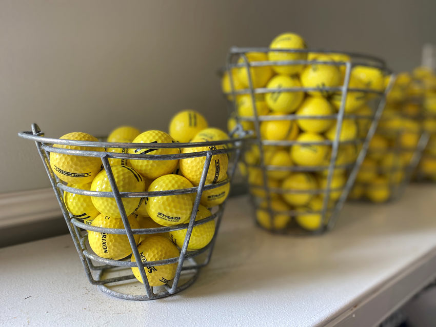 Golf balls in range bucket