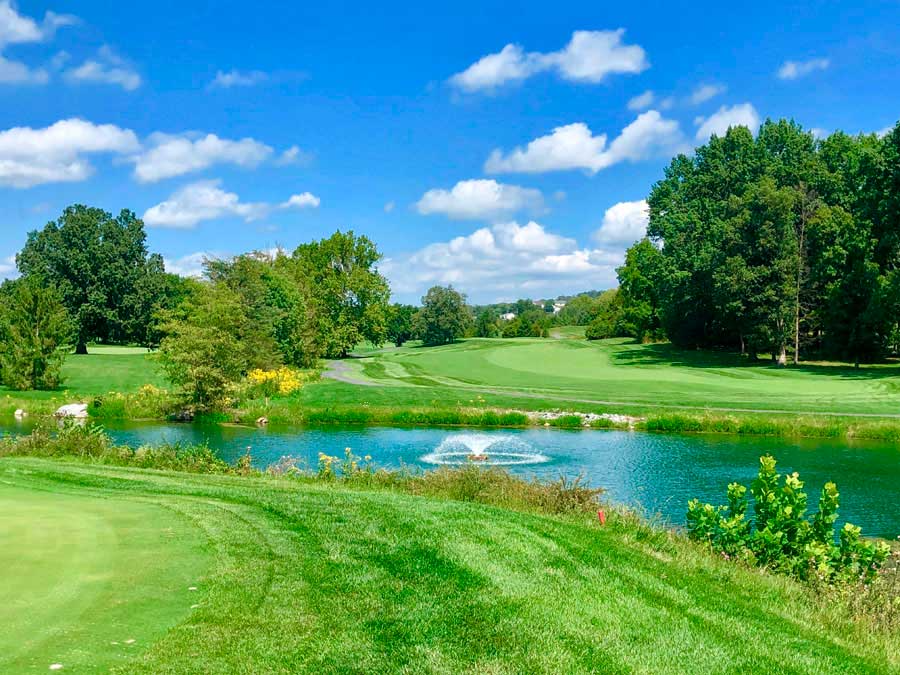 view of golf course fairway with fountain