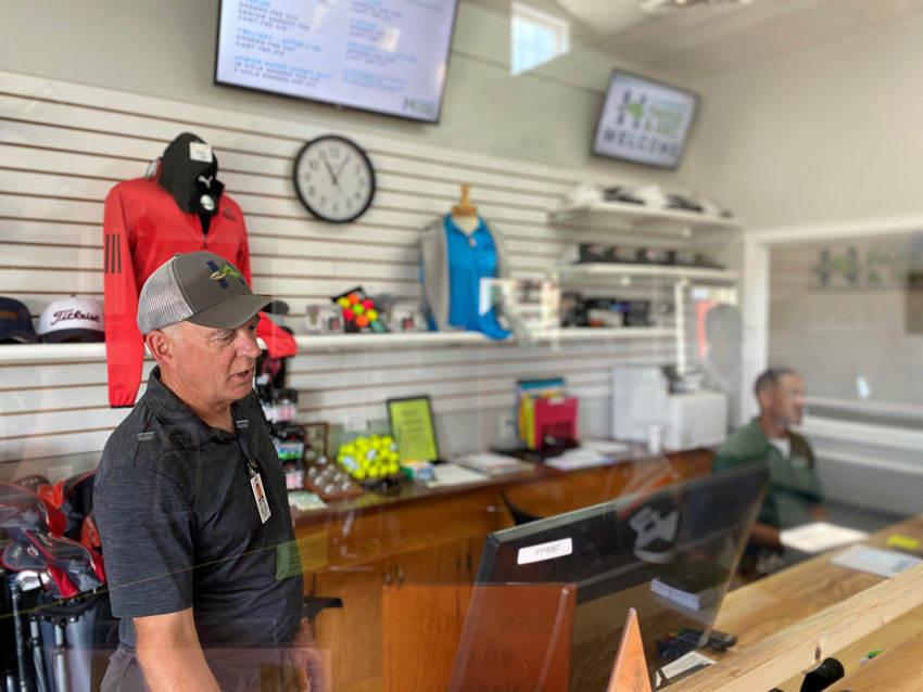 Pro shop staff behind desk