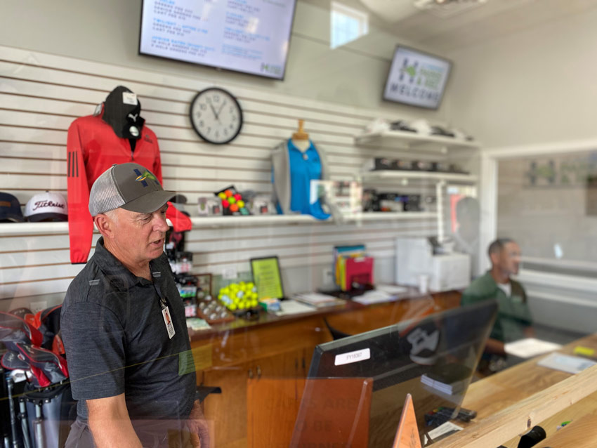 Pro shop staff behind desk 